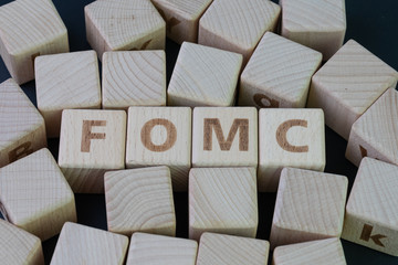 FOMC, Federal Open Market Committee concept, cube wooden block with alphabet building the word FED...