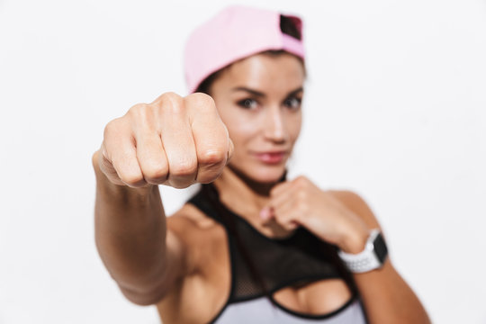 Beautiful young amazing strong sports fitness woman boxer posing isolated over white wall background make exercises.