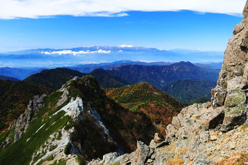 南アルプス塩見岳山頂への道　山頂直下天狗岩越しに中央アルプス、乗鞍岳を望む