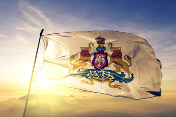 Karnataka state of India flag waving on the top sunrise mist fog