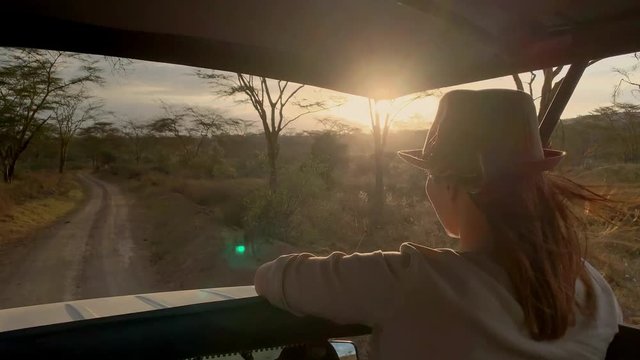Woman on a safari trip in Masai Mara park, Kenya