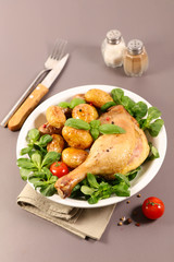 grilled chicken leg with potato and salad