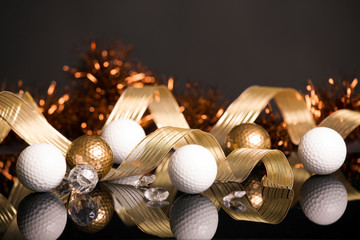 Golf Christmas with golden and white balls on black background