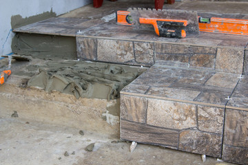 repair of stone stairs,a new ceramic tile to lay on the stairs in the house, laying tiles on the stairs