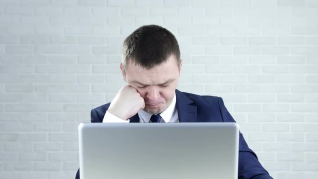 Man waving his head sayiing no while looking at the camera