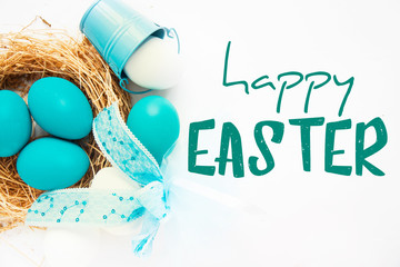 Bright blue colored Easter eggs in nest on wooden background, selective focus image. Happy Easter...