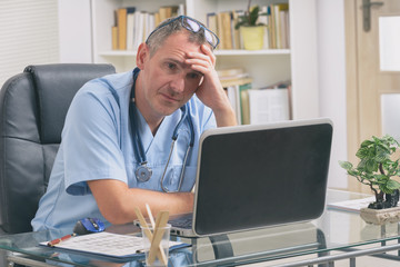 Overworked doctor in his office