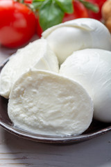 Balls and pieces of buffalo mozzarella, soft Italian scheese made from the milk of Italian Mediterranean buffalo