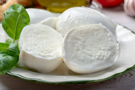 Balls and pieces of buffalo mozzarella, soft Italian scheese made from the milk of Italian Mediterranean buffalo