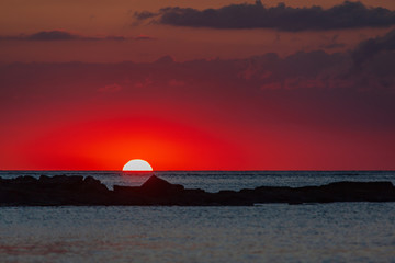 The burning sunset over Indian ocean paints sky in red color, Mauritius island