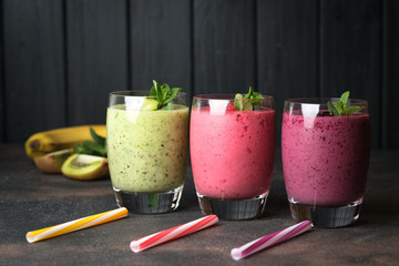Fruit and berry smoothie blend at home against a dark background copy space.