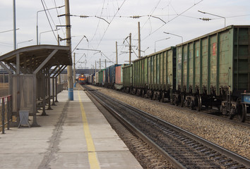 a passenger railway station and an approaching train