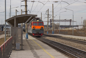 a passenger railway station and an approaching train