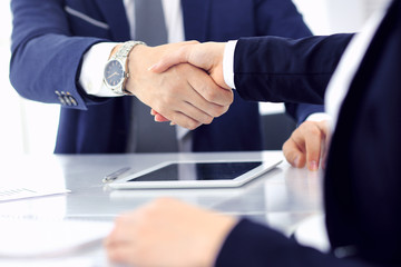 Obraz premium Group of business people or lawyers shaking hands finishing up a meeting , close-up. Success at negotiation and handshake concepts