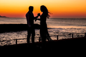 Couple dancing on the pier during sunrise make for awesome silhouettes