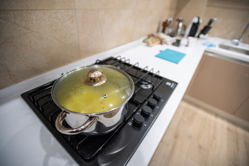 Prepared delicious dinner food pasta or soup or stew in big steel pan, cool down under lid, stand...