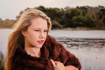 Stunning blonde model in a fur shoulder cape