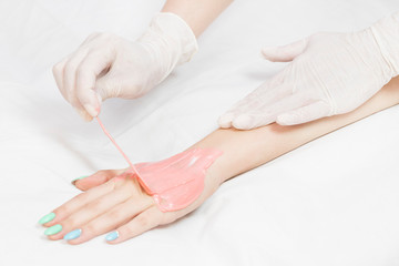 Woman in a beauty salon doing depilation 