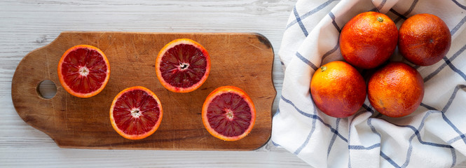 Whole and halved blood oranges, top view. Flat lay, overhead, from above.