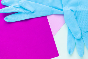 top view of blue rubber gloves on multicolored bright background with copy space