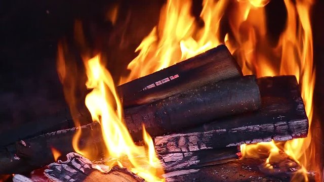 Closeup view of bright cozy burning fire inside of fireplace. Slow motion. Hd video footage.