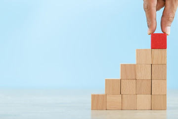 Hand Closer up hands of businessmen,stacking wooden blocks into steps,Concept of business growth success