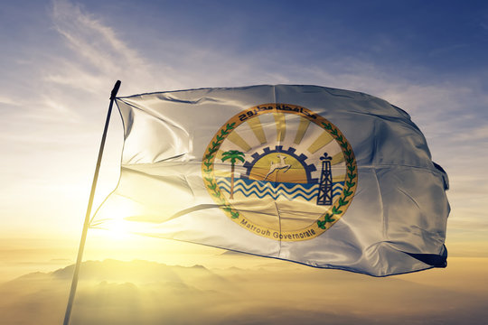 Matrouh governorate of Egypt flag waving on the top sunrise mist fog