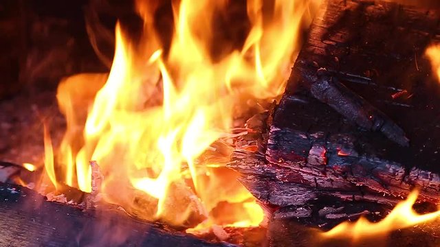 Closeup view of bright cozy burning fire inside of fireplace. Slow motion. Hd video footage.