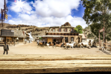 Desk of free space for your decoration. Summer city. Western architecture and running horses