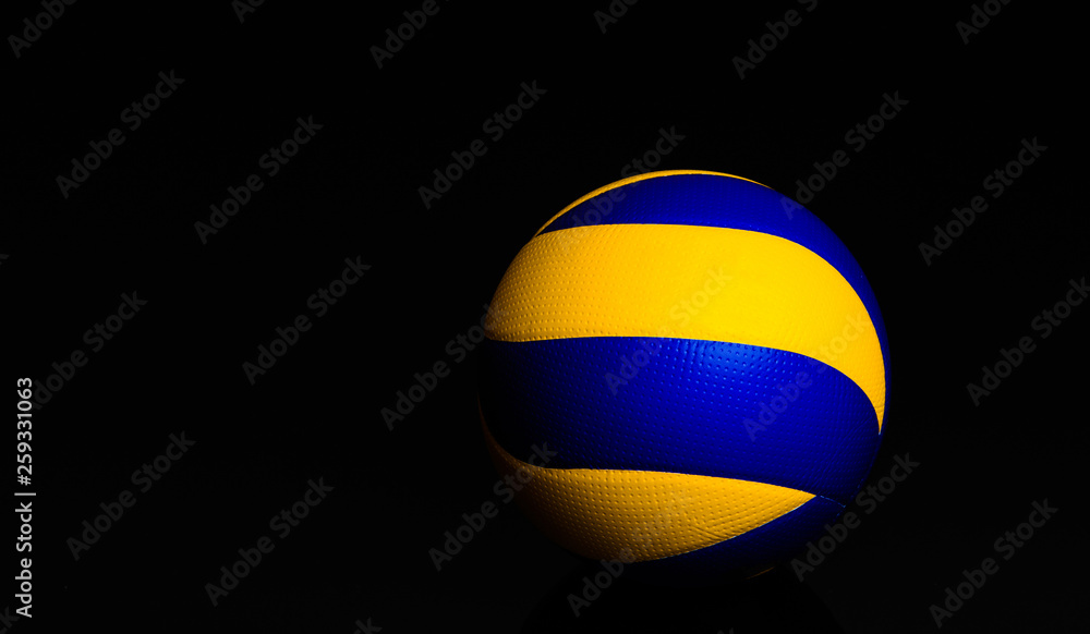 Wall mural volleyball ball on black background.