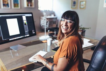 Illustrator working on computer at office