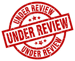 under review round red grunge stamp