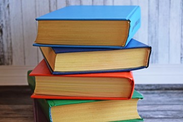 Stack of books on a wooden background.Education.