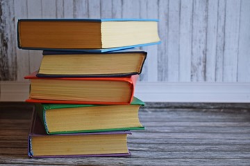 Stack of books on a wooden background.Education.
