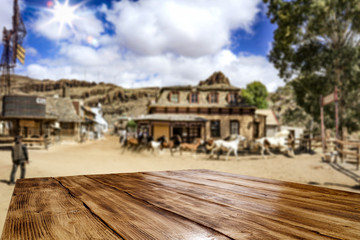 Desk of free space for your decoration. Summer city. Western architecture and running horses