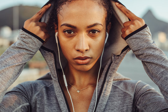 Confident female runner in a hoodie