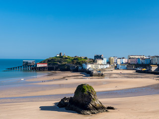 Tenby in Spring. A  beautiful spring day on Tenby north beach.   Goscar Rock in the foreground with...