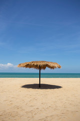 Straw umbrella on the beach for summer vacation tropics,Concept: Lifestyle for leisure travel,symbol tourism for island By the sea