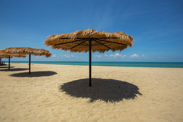 Straw umbrella on the beach for summer vacation tropics,Concept: Lifestyle for leisure travel,symbol tourism for island By the sea