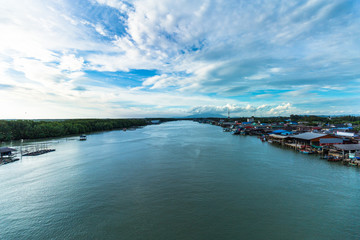 View of boat and sea and city when look from prasae bridge in the evening at rayong province , thailand.