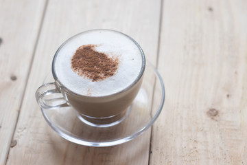 Cup with coffee on a wooden background. Coffee drink. Hot drink. Cappuccino