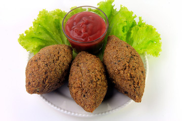 kibbeh on the plate, traditional Lebanese cuisine food, isolated on white background