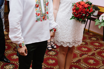 The bride and groom wear wedding rings closeup