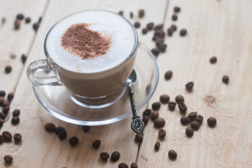 Cup with coffee on a wooden background. Coffee drink. Hot drink. Cappuccino
