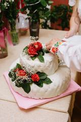 wedding white cake with red roses flowers indoor