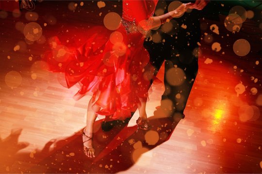 Man and a woman dancing Salsa on background