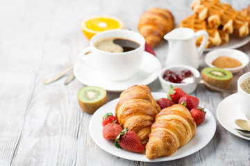 Continental breakfast table with coffee, orange juice, croissants - Powered by Adobe