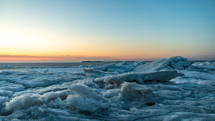 Frozen sea. Snow landscape. Sunset