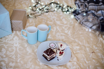 Christmas, New Year, Closeup of Christmas cake and a blue cup  in the background Christmas tree decoration