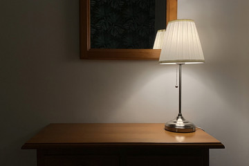 table lamp with lampshade on a wooden table